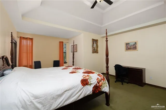 a bedroom with a bed a flat screen tv and a book shelf