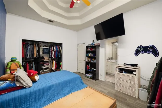 a bedroom with a bed and a chandelier