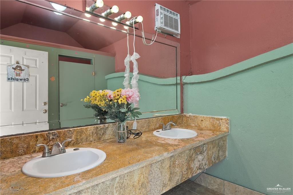 4523 South Tower Road Edinburg, TX 78542 - Photo 28 of 34 a bathroom with a sink and a mirror