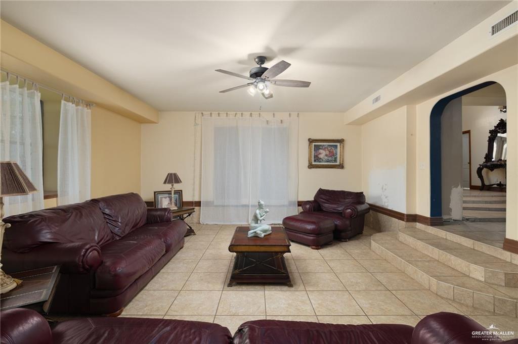 4523 South Tower Road Edinburg, TX 78542 - Photo 10 of 34 a living room with furniture and a chandelier