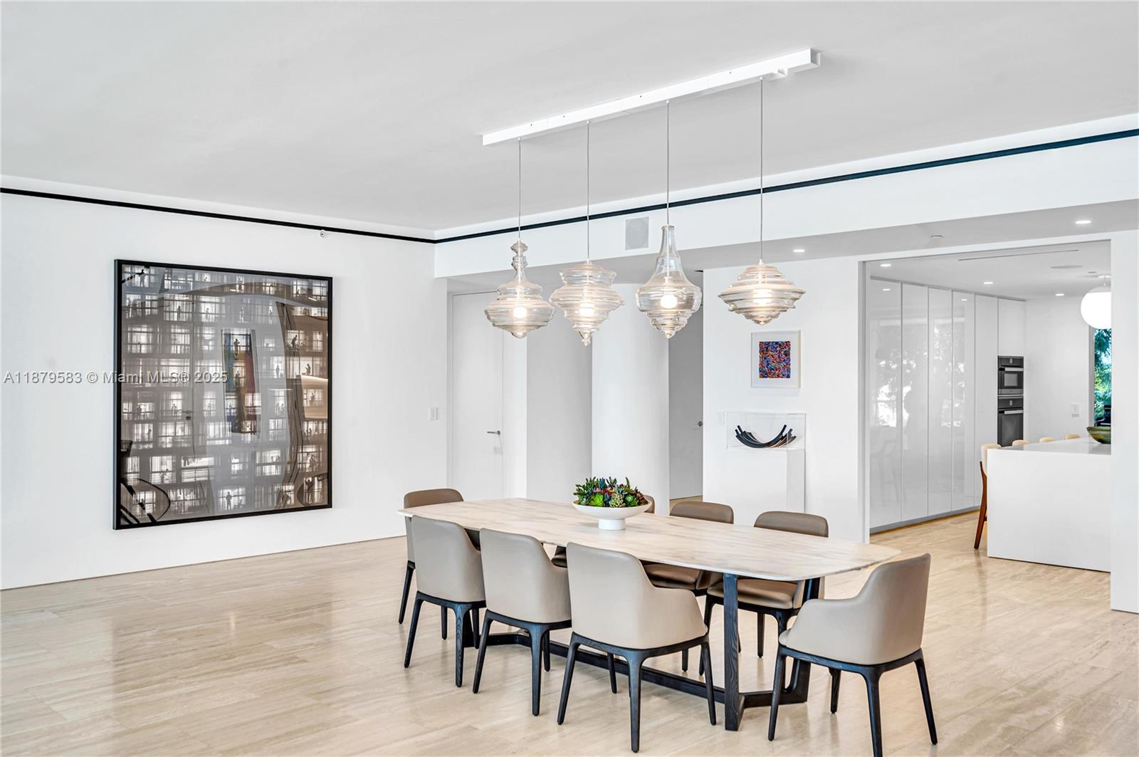 9001 Collins Avenue, Unit S201 Surfside, FL 33154 - Photo 15 of 44 a view of a dining room with furniture and wooden floor