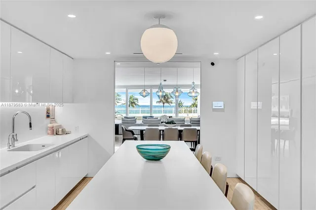 a kitchen with a sink and living room