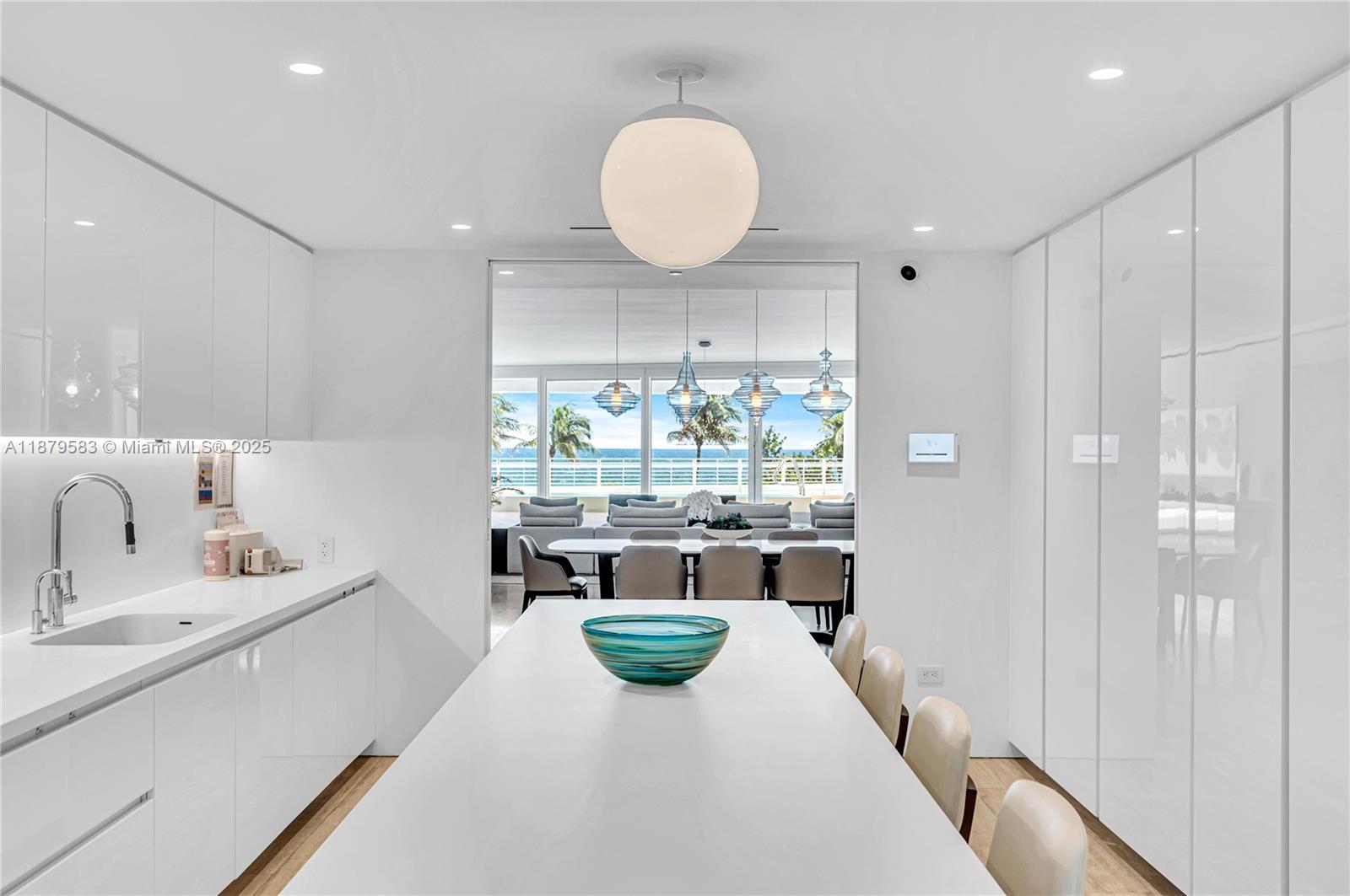 9001 Collins Avenue, Unit S201 Surfside, FL 33154 - Photo 19 of 44 a kitchen with a sink and living room