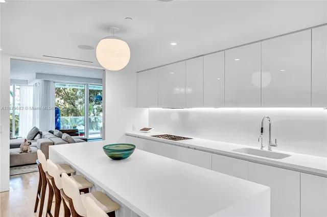 a kitchen with a table chairs and a refrigerator