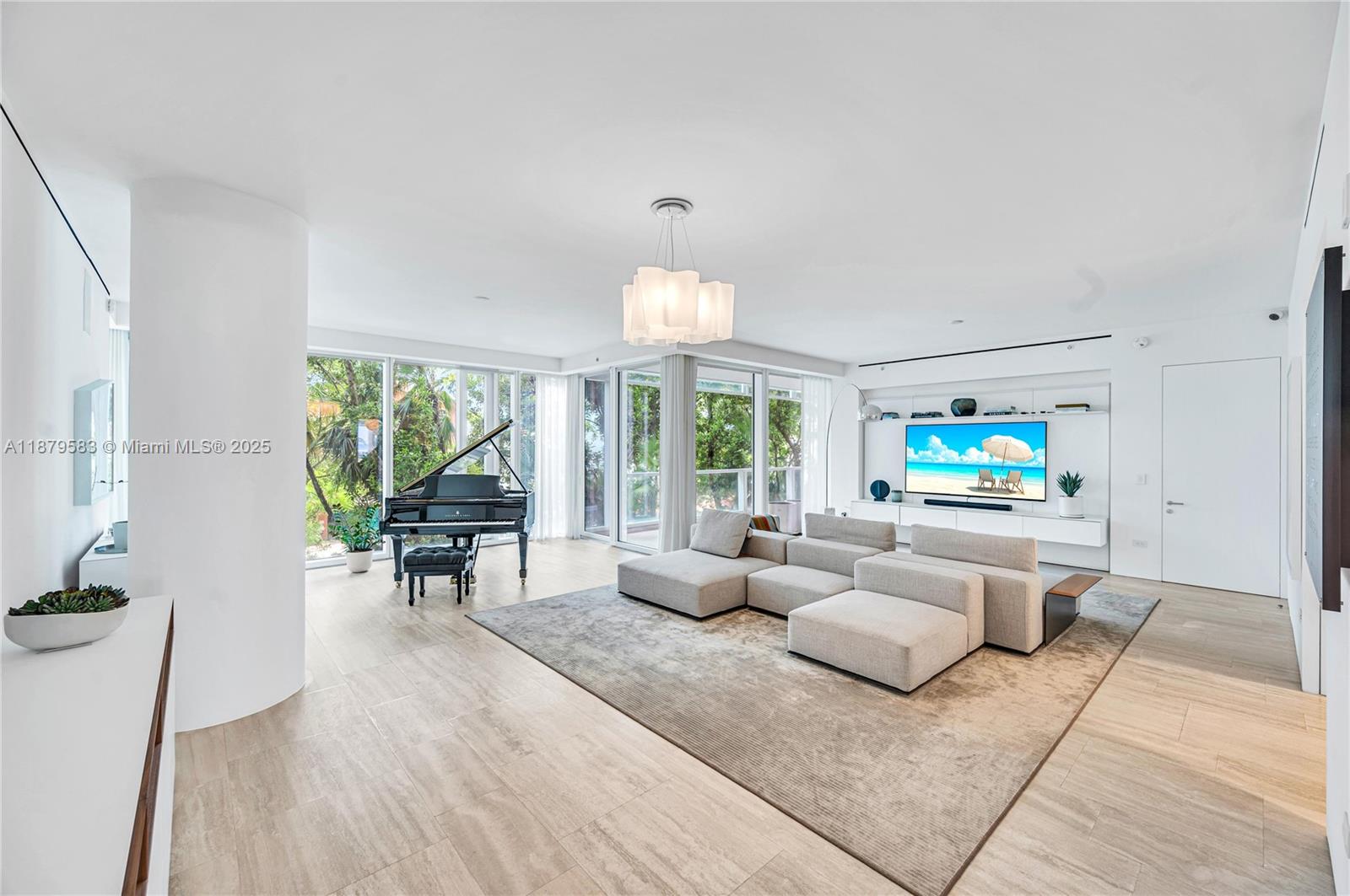 9001 Collins Avenue, Unit S201 Surfside, FL 33154 - Photo 24 of 44 a living room with furniture and a flat screen tv