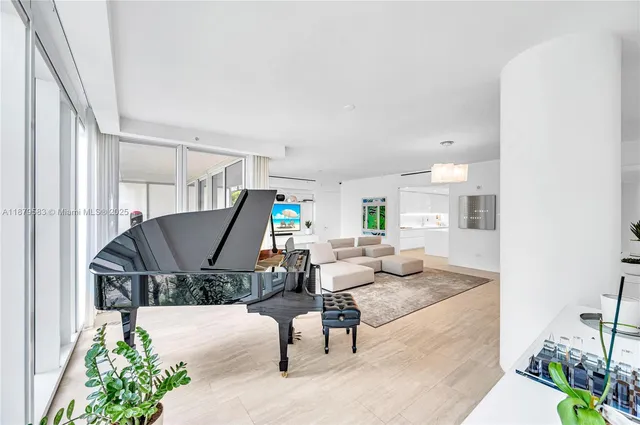 a living room with furniture and a piano