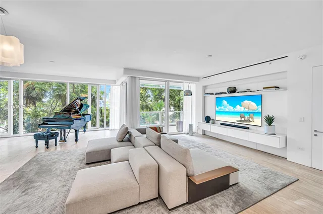 a living room with furniture large window and a flat screen tv