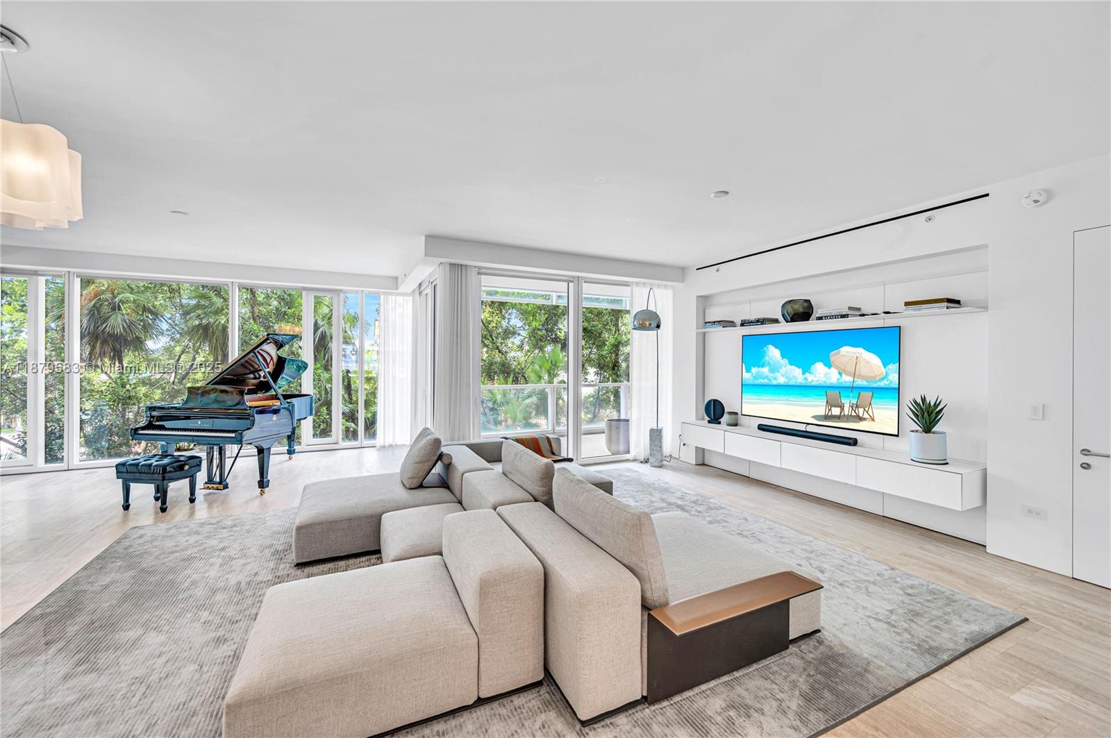 9001 Collins Avenue, Unit S201 Surfside, FL 33154 - Photo 28 of 44 a living room with furniture large window and a flat screen tv