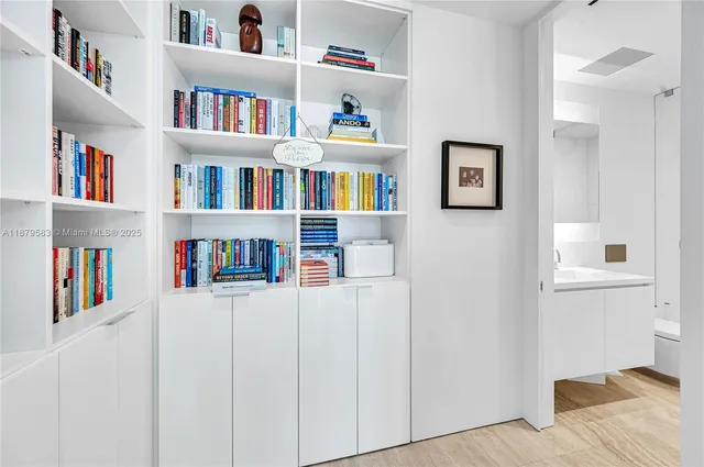 a bedroom with a bed and a book shelf
