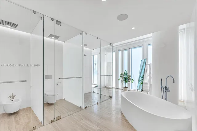 a bathroom with a bathtub and a shower