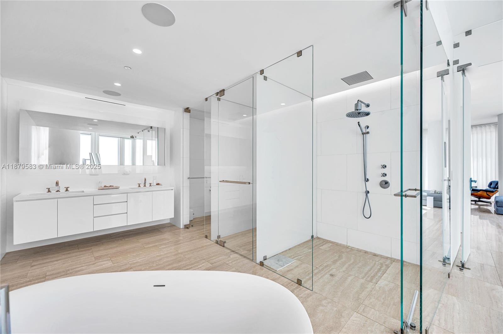 9001 Collins Avenue, Unit S201 Surfside, FL 33154 - Photo 36 of 44 a bathroom with a tub sink shower and mirror