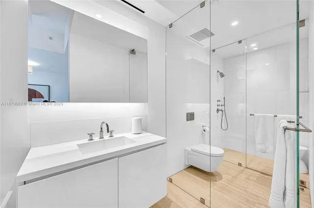 a bathroom with a sink toilet and shower