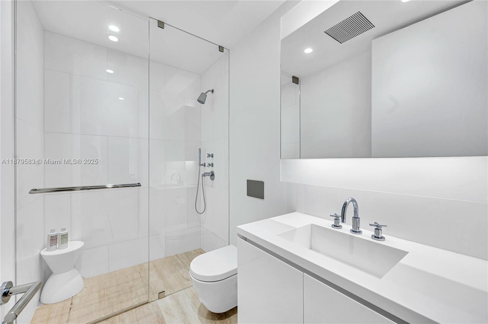 9001 Collins Avenue, Unit S201 Surfside, FL 33154 - Photo 43 of 44 a bathroom with a sink toilet and shower