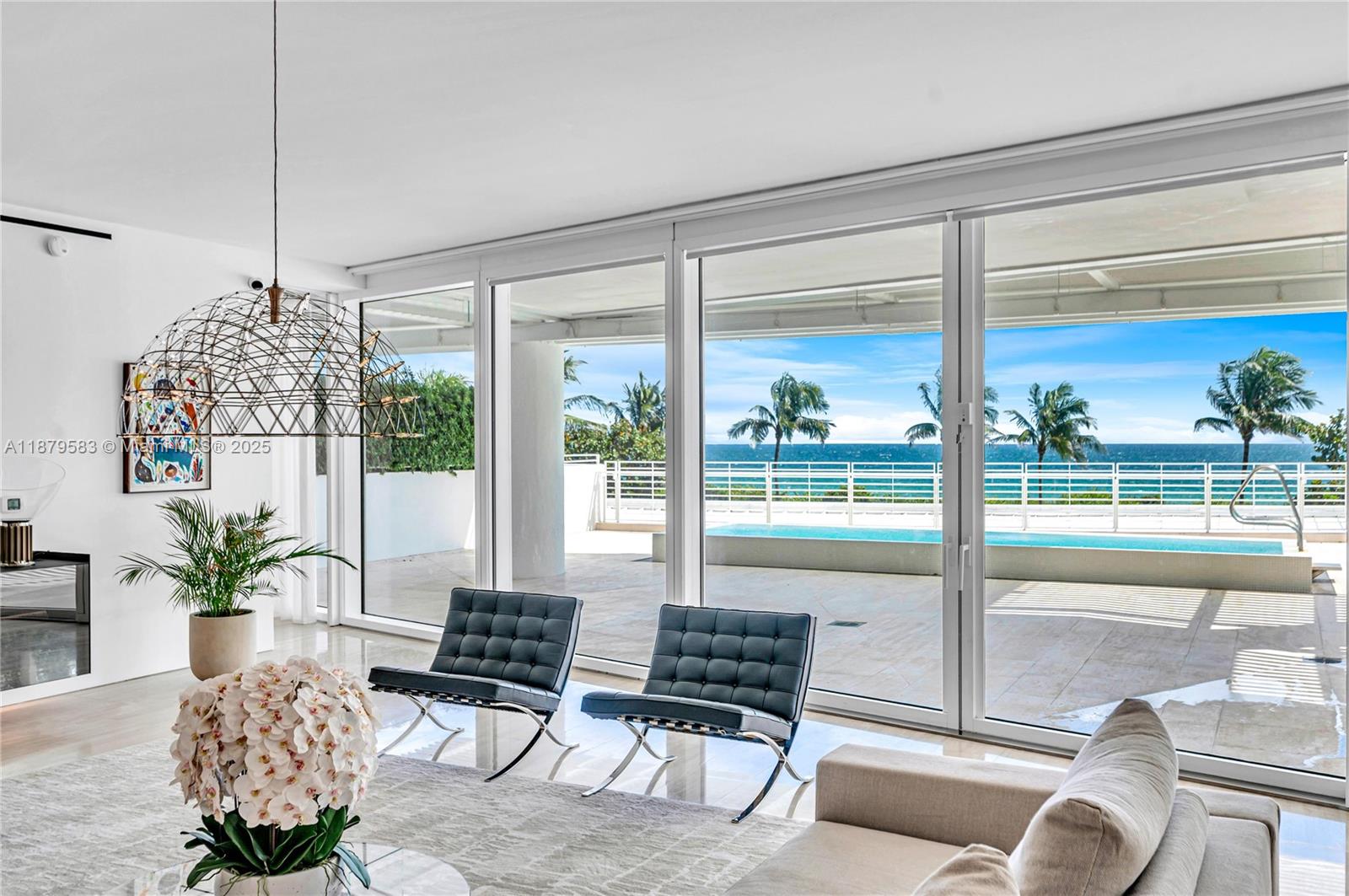 9001 Collins Avenue, Unit S201 Surfside, FL 33154 - Photo 9 of 44 a living room with furniture and a floor to ceiling window