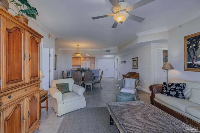 a living room with furniture a ceiling fan and a window
