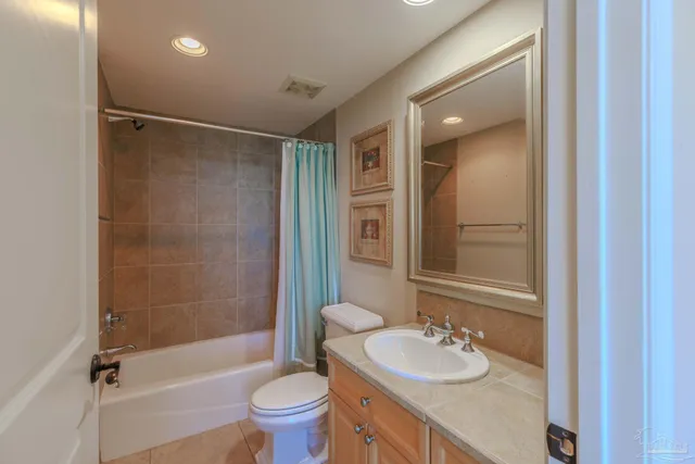 a bathroom with a granite countertop sink toilet mirror and shower