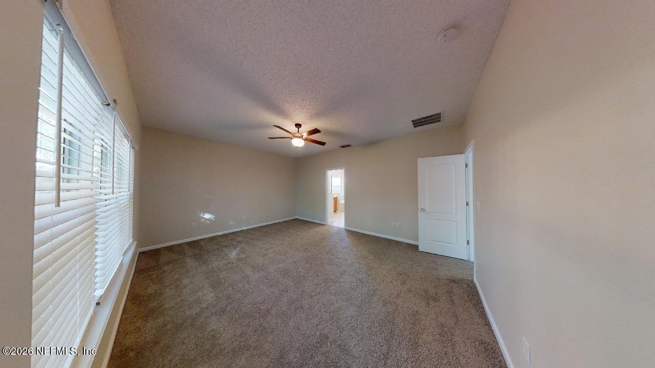 14454 Millhopper Road Jacksonville, FL 32258 - Photo 20 of 44 a view of an empty room with a window