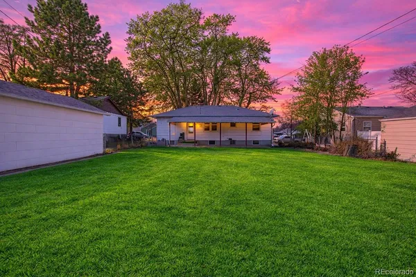 a view of house with a yard