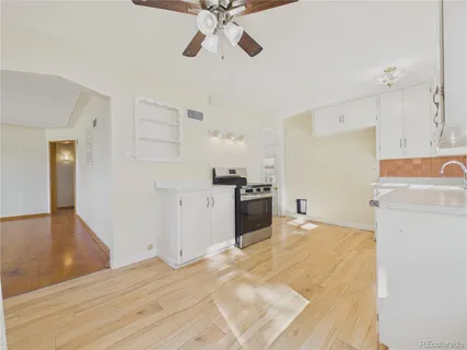a view of a kitchen with a sink dishwasher a refrigerator with wooden cabinets