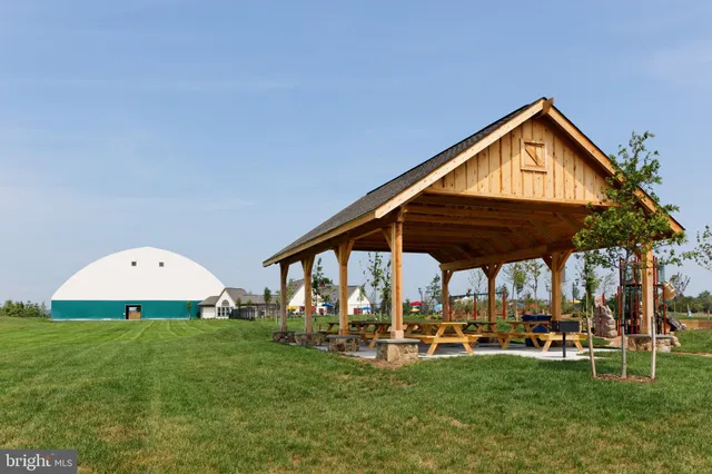 a view of swimming pool with chairs and a yard