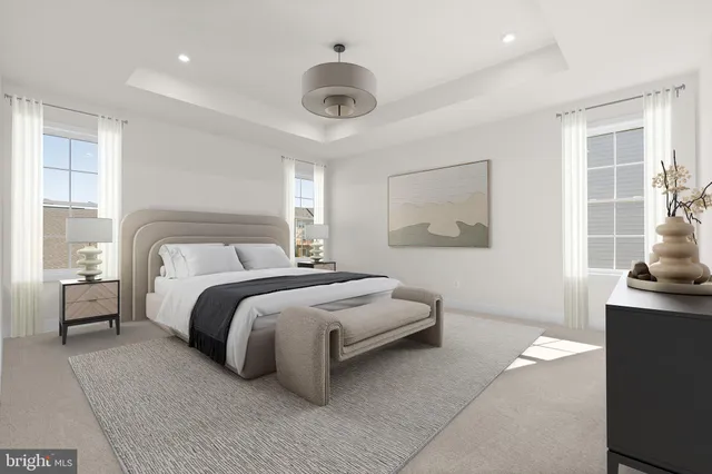 a spacious bedroom with a bed and a large window