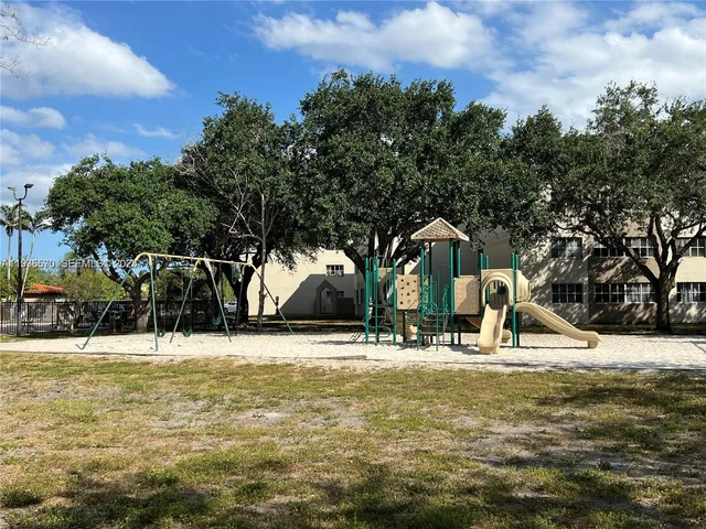 a backyard of apartments with large trees