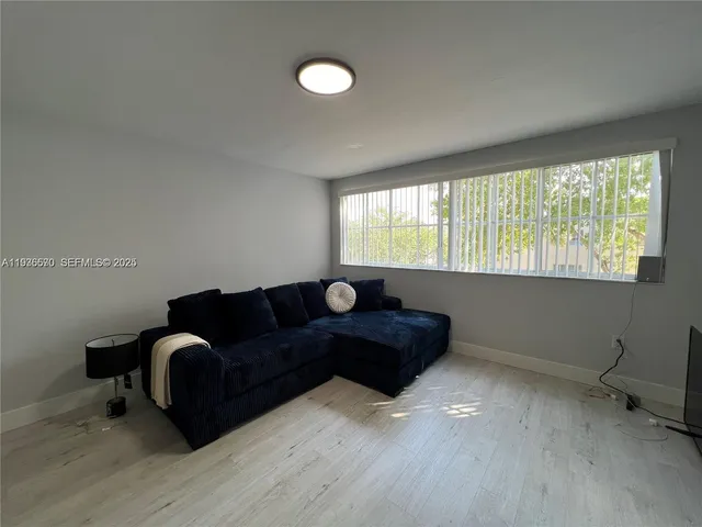 a living room with furniture and a window