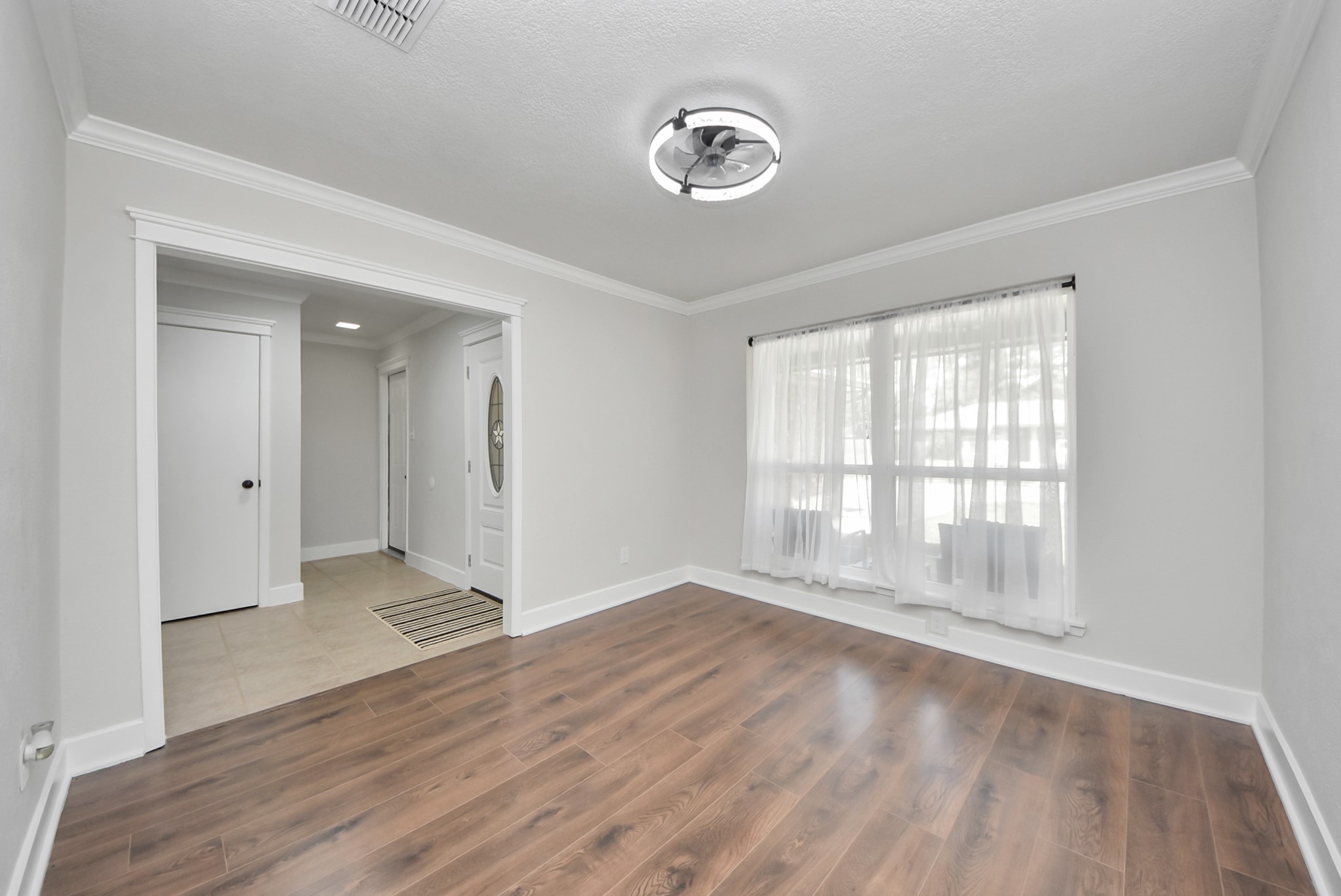 5314 Sweetwind Lane Spring, TX 77373 - Photo 8 of 47 Natural lighting, and modern lighting fixture, leading to a tiled entryway.
