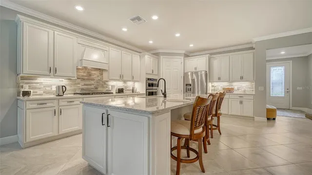 a kitchen with stainless steel appliances granite countertop wooden cabinets a stove top oven a sink and dishwasher