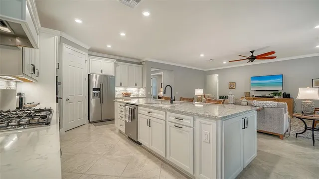 a kitchen with a sink refrigerator and cabinets