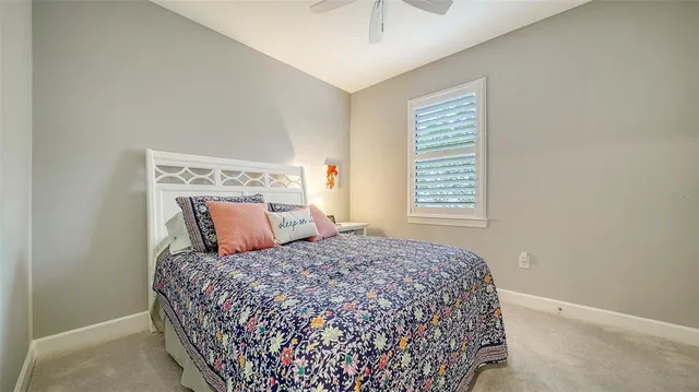 a bed sitting in a bedroom next to a window