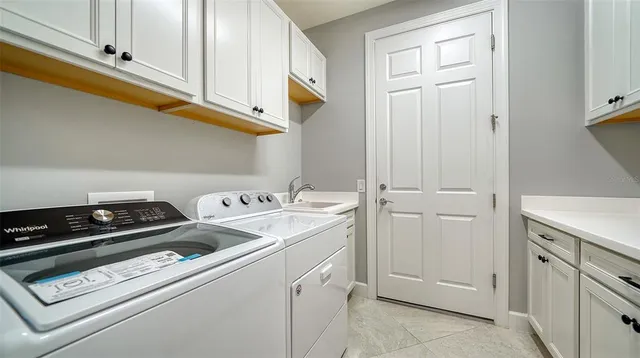 a view of a storage and utility room with washer and dryer