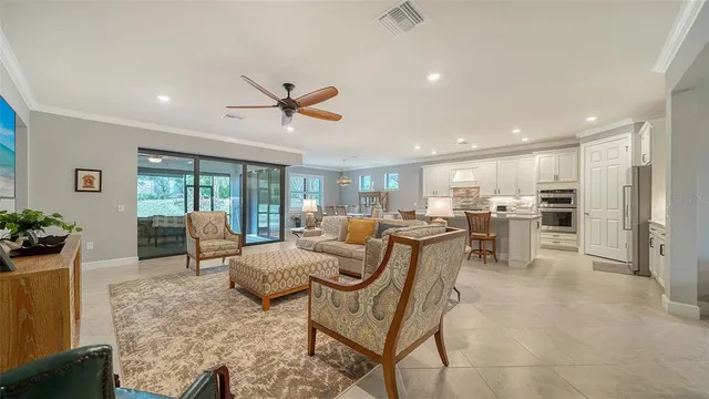 a room with lots of chairs and view of living room