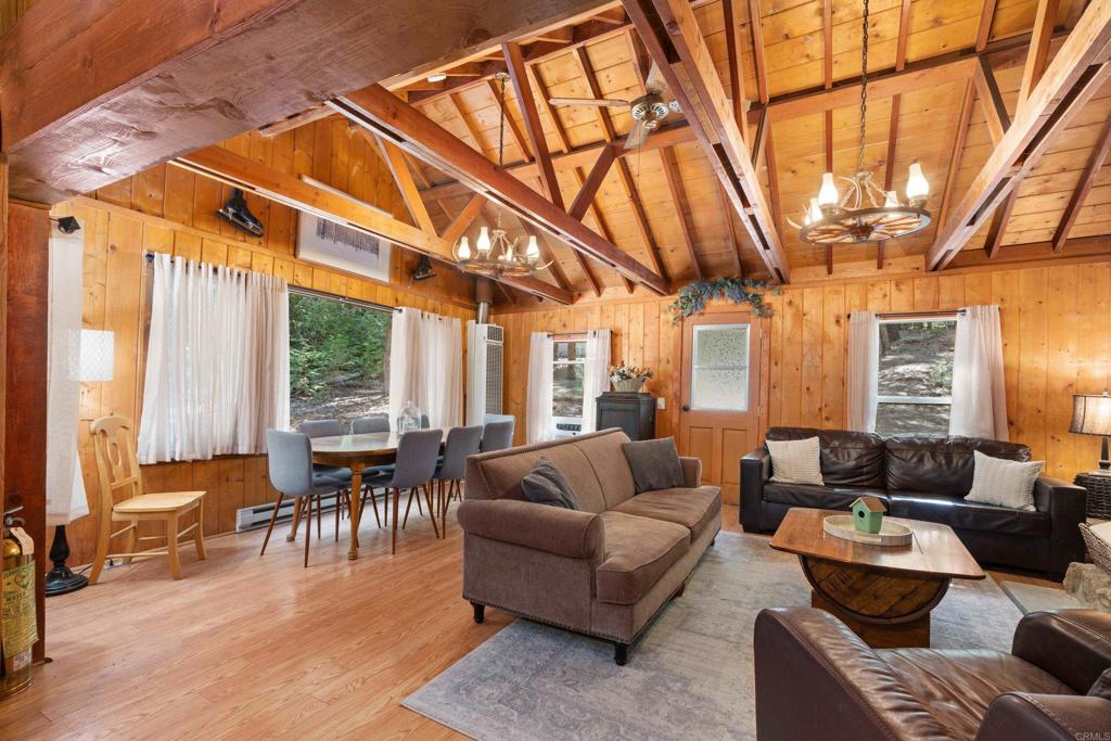 22194 Crestline Road Palomar Mountain, CA 92060 - Photo 14 of 75 a living room with furniture a wooden floor and a large window