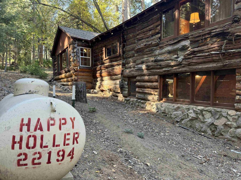 22194 Crestline Road Palomar Mountain, CA 92060 - Photo 24 of 75 a view of a wooden house with a sign on the wall