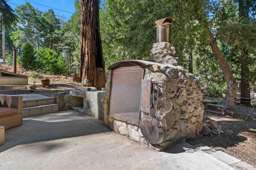 22194 Crestline Road Palomar Mountain, CA 92060 - Photo 36 of 75 a view of a chairs and table in the back yard of the house