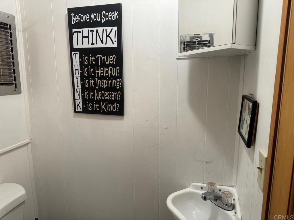 22194 Crestline Road Palomar Mountain, CA 92060 - Photo 49 of 75 a bathroom with a toilet and a sink