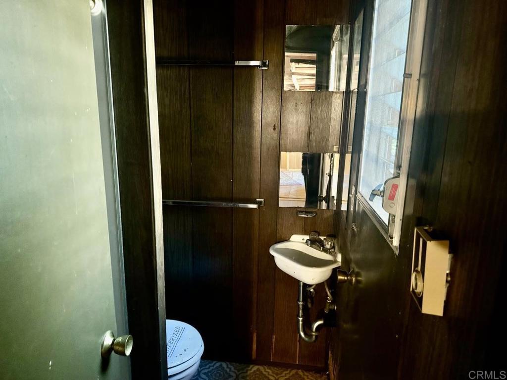 22194 Crestline Road Palomar Mountain, CA 92060 - Photo 62 of 75 a bathroom with a sink a toilet and mirror