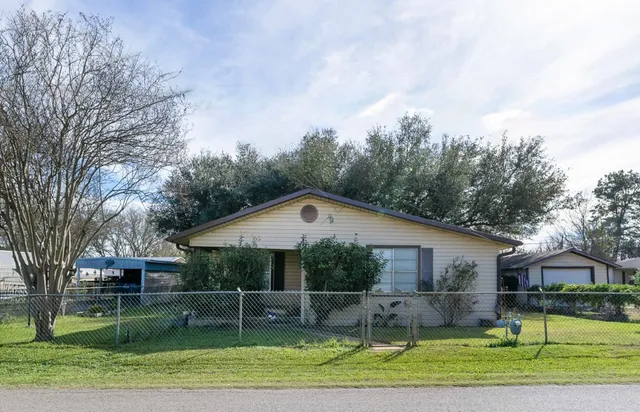 a front view of a house with a yard table and chairs