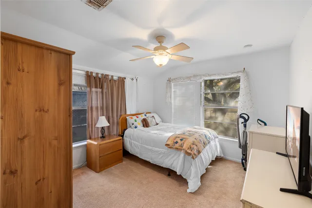 a bed sitting in a bedroom next to a window