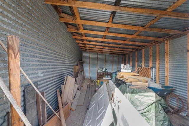 a view of a patio with table and chairs with wooden floor and fence