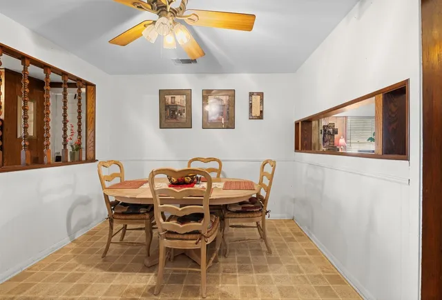 a dining room with furniture and window