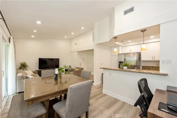 a dining room with furniture and a flat screen tv