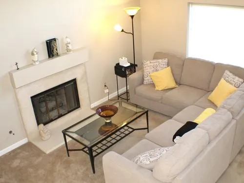 a living room with furniture and a fireplace