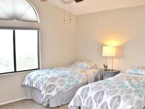 a bedroom with two beds and a window