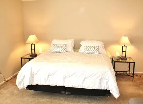 a bedroom with a bed and a lamp