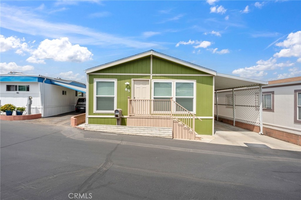 65 Hummingbird Lane Oceanside, CA 92057 - Photo 2 of 38 a house view with a garden space