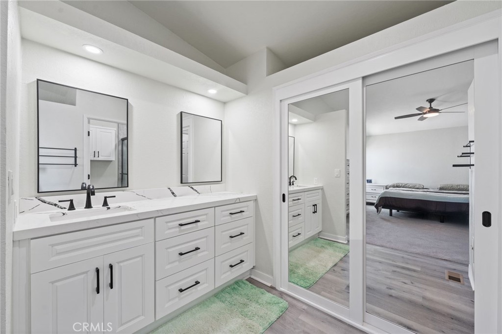 65 Hummingbird Lane Oceanside, CA 92057 - Photo 21 of 38 a en suite bathroom with a double vanity sink and mirror