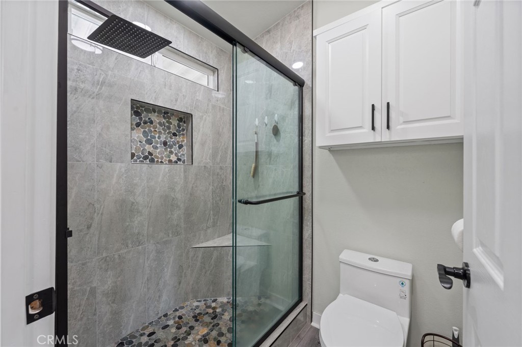 65 Hummingbird Lane Oceanside, CA 92057 - Photo 23 of 38 a bathroom with a toilet and a shower