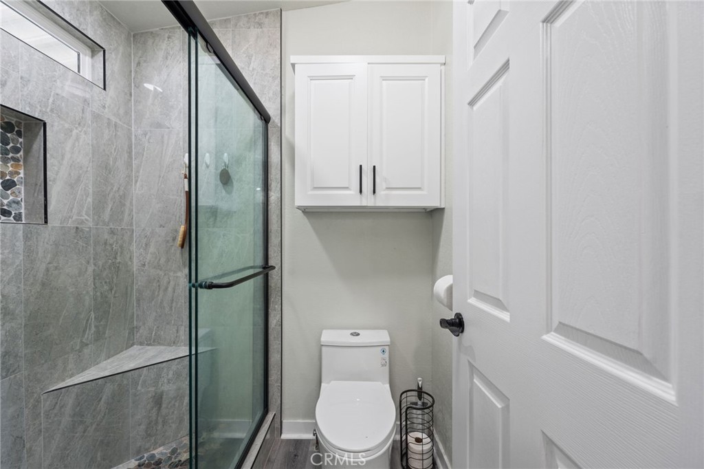 65 Hummingbird Lane Oceanside, CA 92057 - Photo 24 of 38 a bathroom with a toilet and a shower